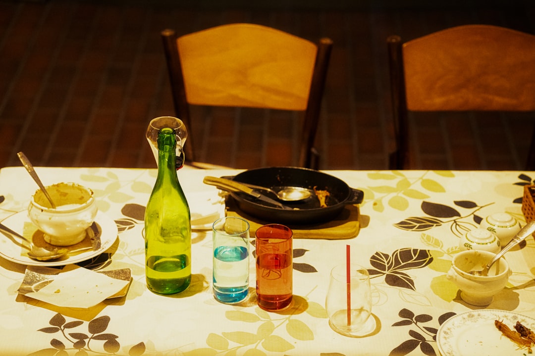 a-table-topped-with-a-bottle-of-wine-next-to-a-plate-of-food-iq9z9fyitue