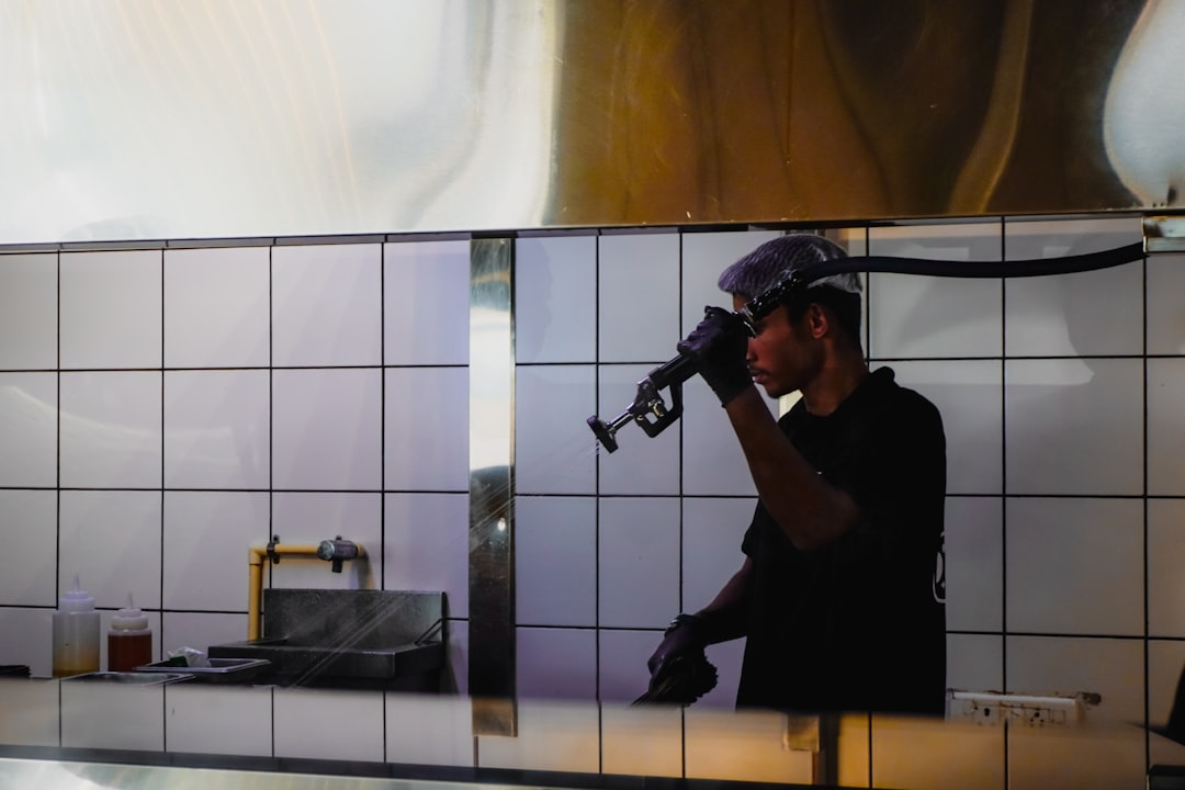 man-in-black-shirt-and-hard-hat-using-a-tool-aywiw8h8h50